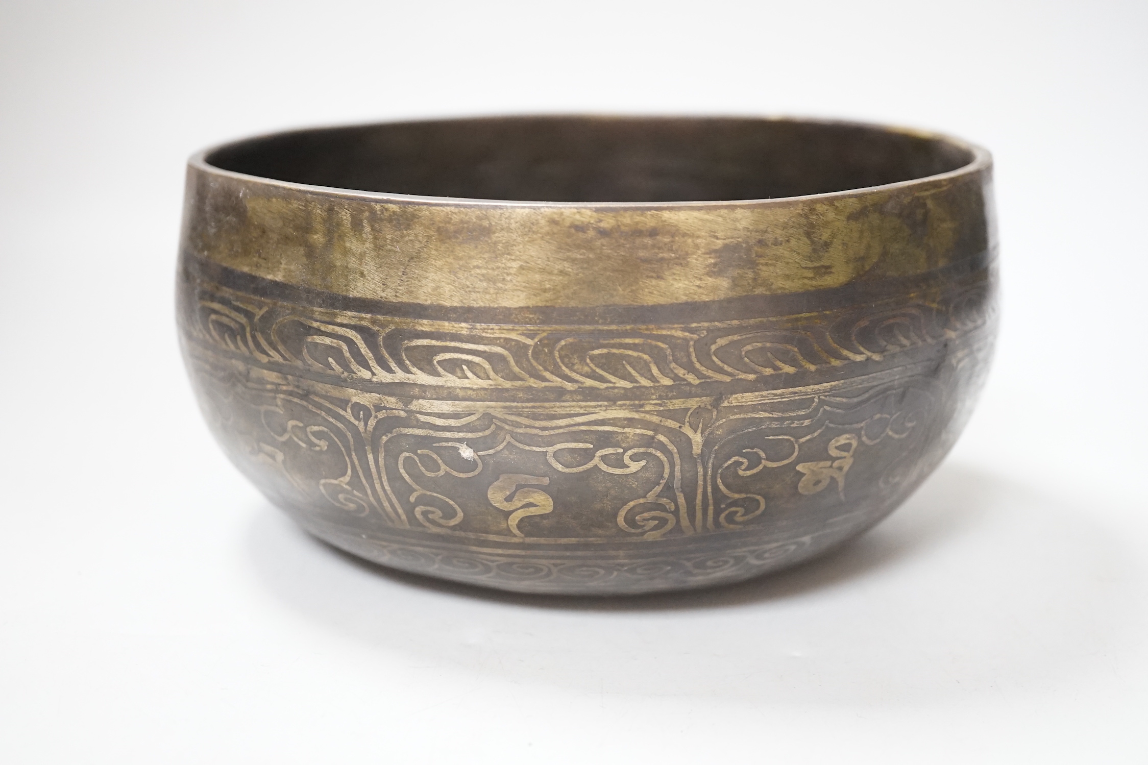 A Tibetan singing bowl with Sanskrit inscription, 19cm diameter